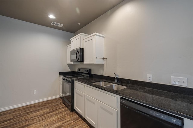 kitchen with white cabinets, sink, dark stone countertops, and black appliances