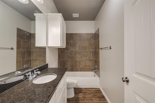 full bathroom with hardwood / wood-style floors, vanity, toilet, and bathing tub / shower combination