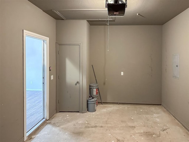 garage with electric panel and a garage door opener