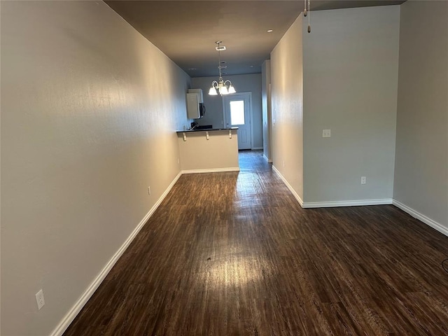 1017 SW 91st St, Oklahoma City, OK 73139 - unfurnished dining area with dark wood-style floors, a chandelier, and baseboards