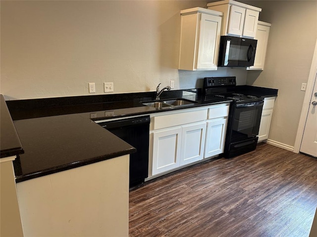 1017 SW 91st St, Oklahoma City, OK 73139 - kitchen with black appliances, a sink, dark wood finished floors, dark countertops, and white cabinetry