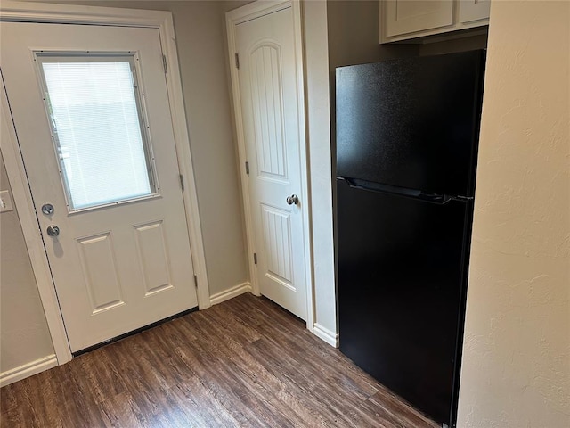 1017 SW 91st St, Oklahoma City, OK 73139 - kitchen with freestanding refrigerator, dark wood-style floors, baseboards, and white cabinetry