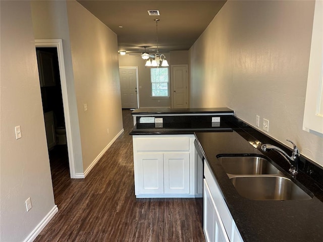 1017 SW 91st St, Oklahoma City, OK 73139 - kitchen with a sink, white cabinetry, dark wood-type flooring, a peninsula, and baseboards