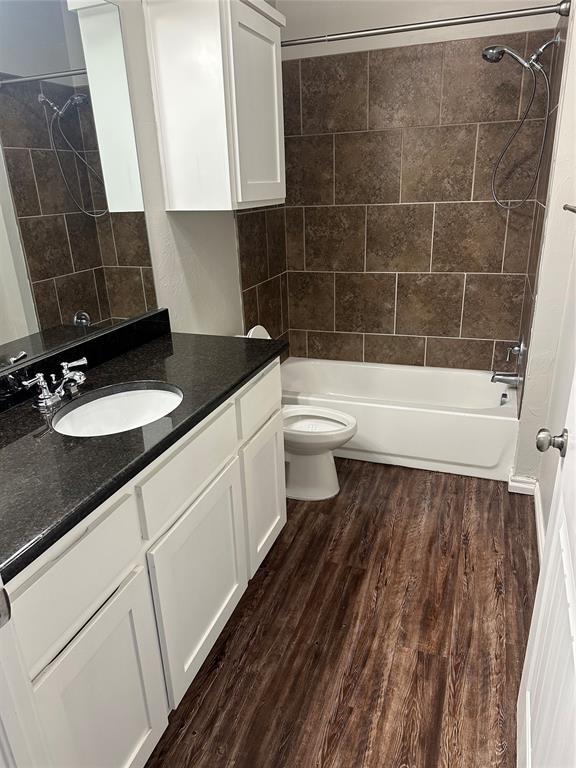 1017 SW 91st St, Oklahoma City, OK 73139 - bathroom with vanity, toilet, wood finished floors, and shower / bath combination