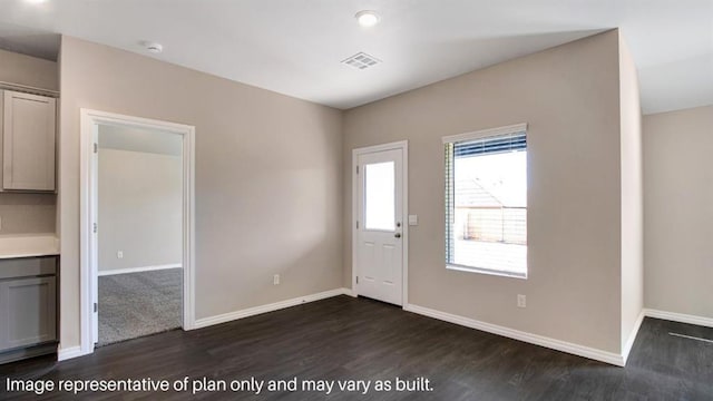 entryway featuring dark wood-style flooring, visible vents, and baseboards