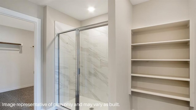 full bathroom with a spacious closet, a marble finish shower, and baseboards