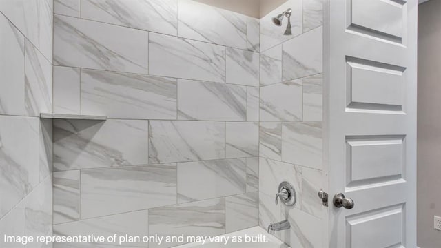 interior details featuring washtub / shower combination