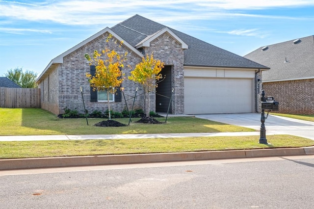 view of front of house featuring a garage and a front yard