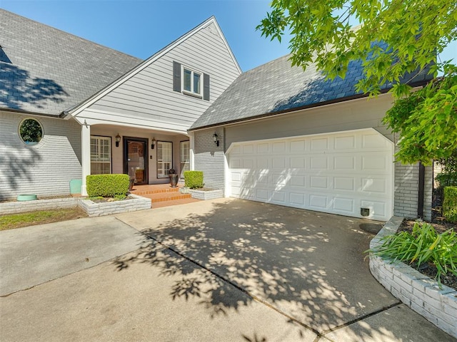 view of front facade featuring covered porch and a garage