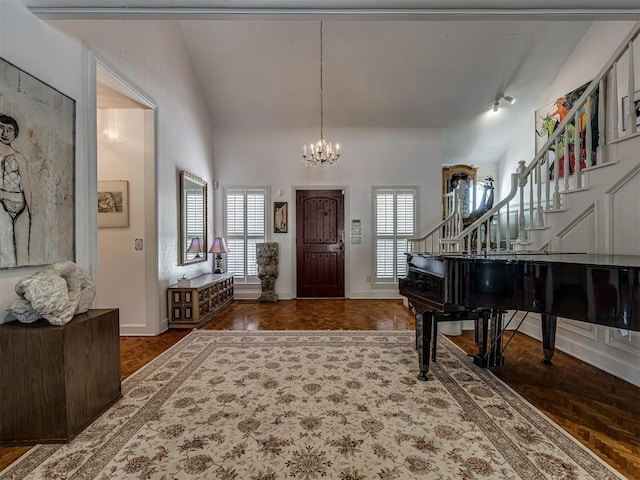 entryway featuring vaulted ceiling, dark wood-type flooring, and an inviting chandelier