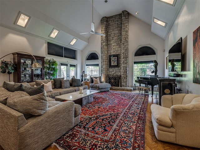 living room featuring plenty of natural light, ceiling fan, and high vaulted ceiling