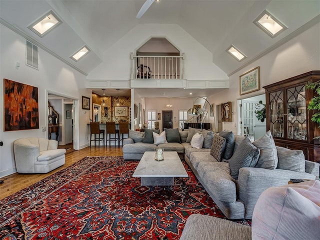 living room with wood-type flooring and high vaulted ceiling