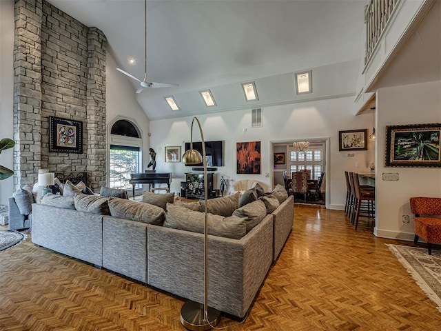 living room with a stone fireplace, ceiling fan, high vaulted ceiling, and parquet floors