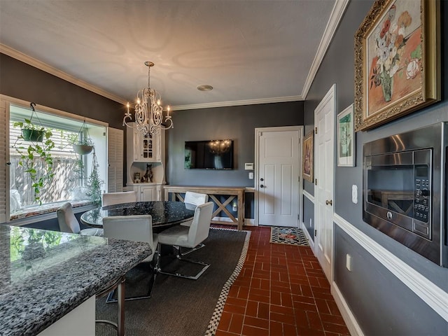 dining area featuring an inviting chandelier and ornamental molding