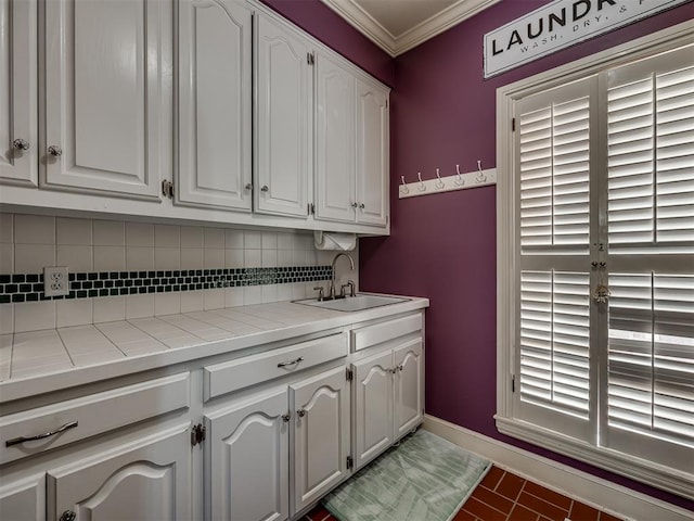 washroom featuring tile patterned floors, crown molding, and sink