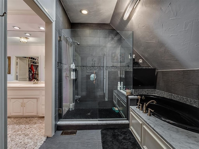 bathroom featuring tile patterned flooring, crown molding, vaulted ceiling, vanity, and independent shower and bath