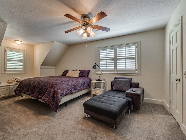 carpeted bedroom with a textured ceiling, ceiling fan, and lofted ceiling