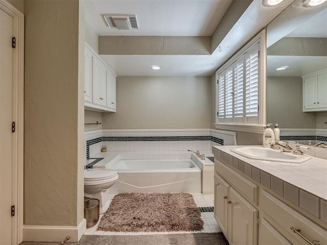 bathroom with tile patterned flooring, a bathtub, toilet, and vanity