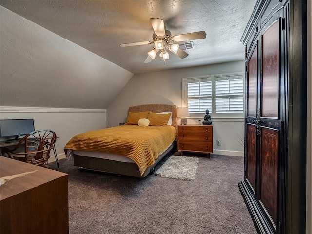 carpeted bedroom with a textured ceiling, ceiling fan, and vaulted ceiling