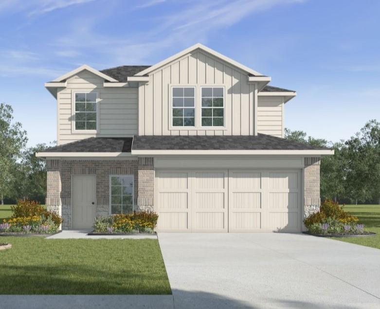 view of front of home with a garage, brick siding, driveway, board and batten siding, and a front yard