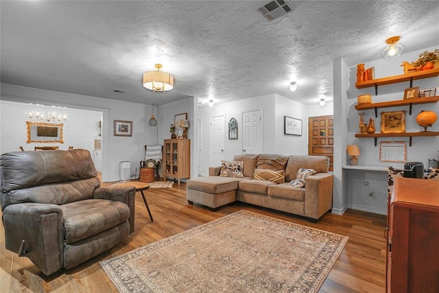 living room featuring hardwood / wood-style flooring and a textured ceiling