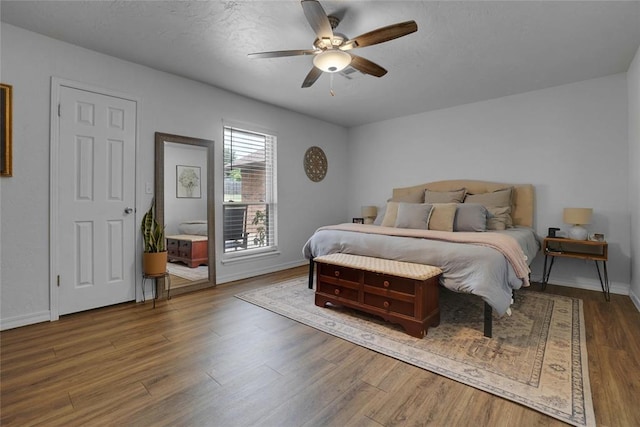 bedroom featuring ceiling fan and dark wood-type flooring