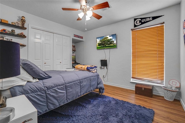 bedroom featuring a closet, ceiling fan, and light hardwood / wood-style flooring