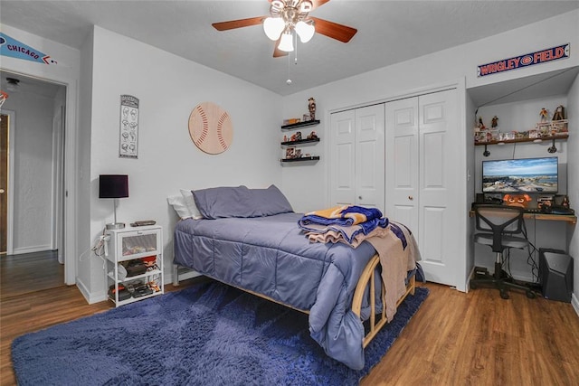 bedroom with hardwood / wood-style flooring, ceiling fan, and a closet