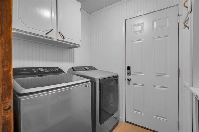 laundry area featuring cabinets, independent washer and dryer, and ornamental molding