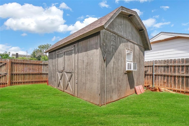 view of outbuilding with cooling unit and a yard