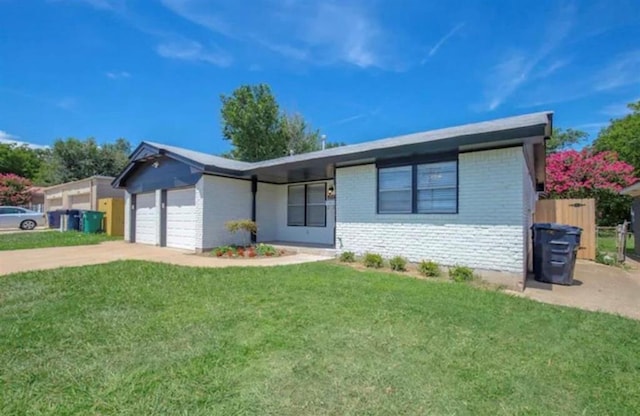 single story home featuring a garage and a front lawn