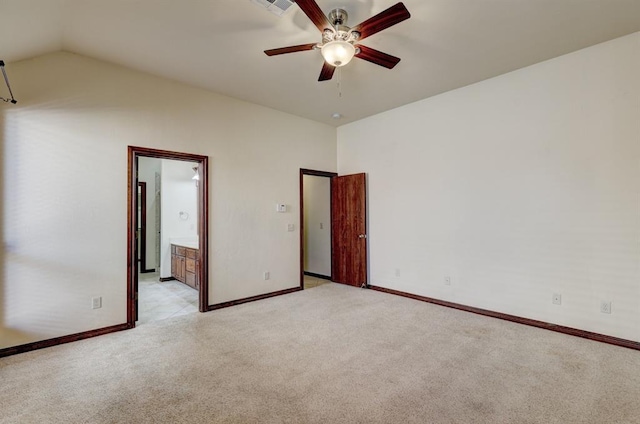 carpeted spare room featuring ceiling fan and vaulted ceiling