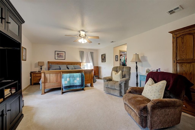 bedroom featuring ceiling fan and light carpet