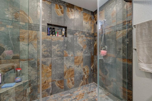 bathroom with a tile shower