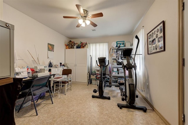 workout area featuring ceiling fan and light colored carpet