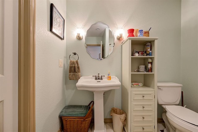 bathroom featuring toilet and sink