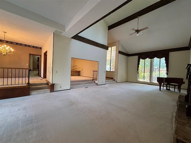 unfurnished living room with carpet, ceiling fan with notable chandelier, beam ceiling, and high vaulted ceiling