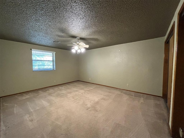 unfurnished bedroom with light carpet, a textured ceiling, and ceiling fan