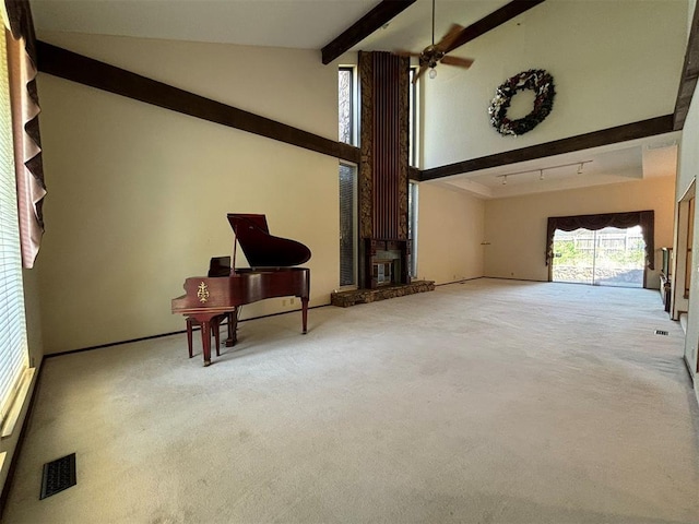 interior space featuring carpet, ceiling fan, beamed ceiling, and high vaulted ceiling