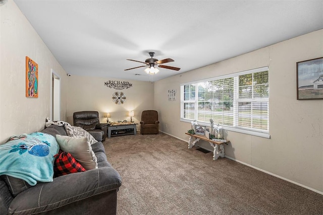 carpeted living room with ceiling fan