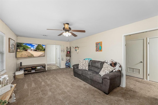 living room featuring carpet and ceiling fan