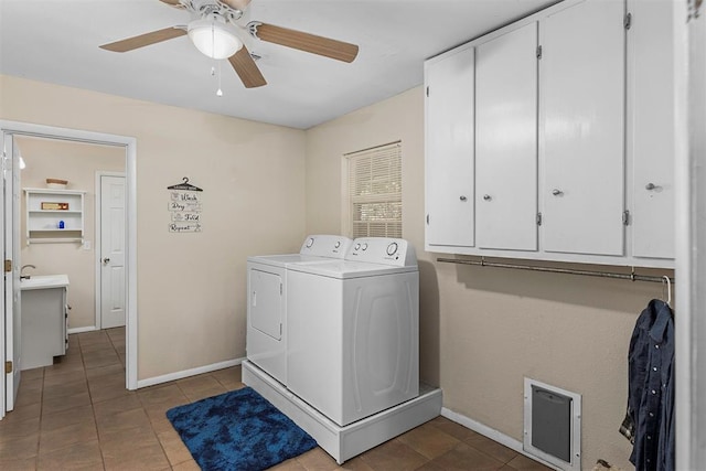 washroom with washing machine and dryer, light tile patterned floors, and cabinets