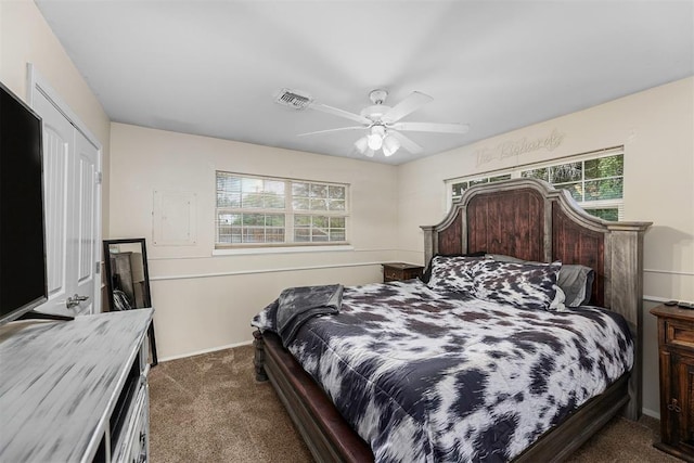 carpeted bedroom featuring ceiling fan and multiple windows