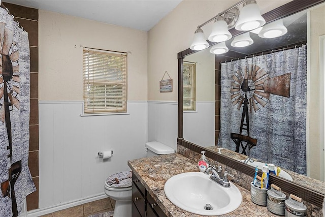 bathroom with curtained shower, tile patterned flooring, vanity, and toilet