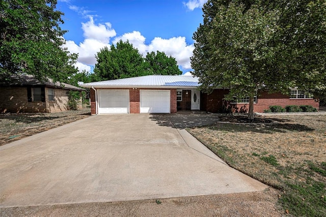 ranch-style house with a garage and a front yard