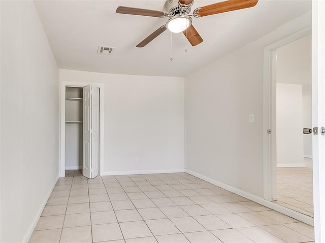 unfurnished bedroom with ceiling fan and light tile patterned flooring