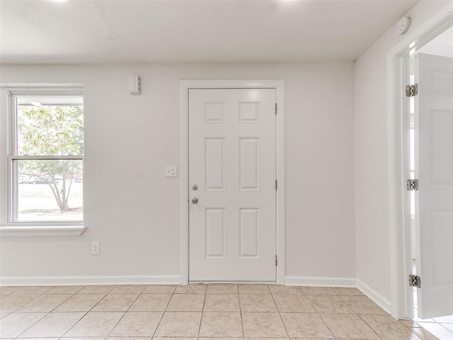 entryway with light tile patterned flooring