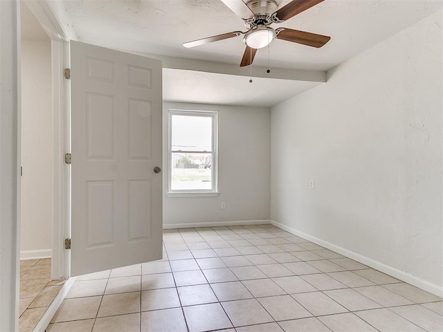 tiled empty room with ceiling fan