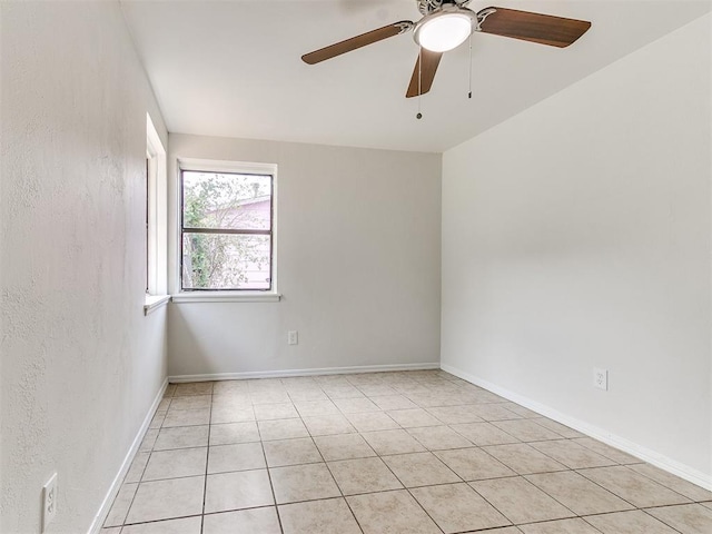 spare room featuring ceiling fan and light tile patterned flooring