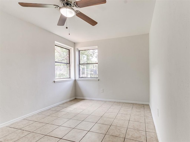 unfurnished room with ceiling fan and light tile patterned flooring